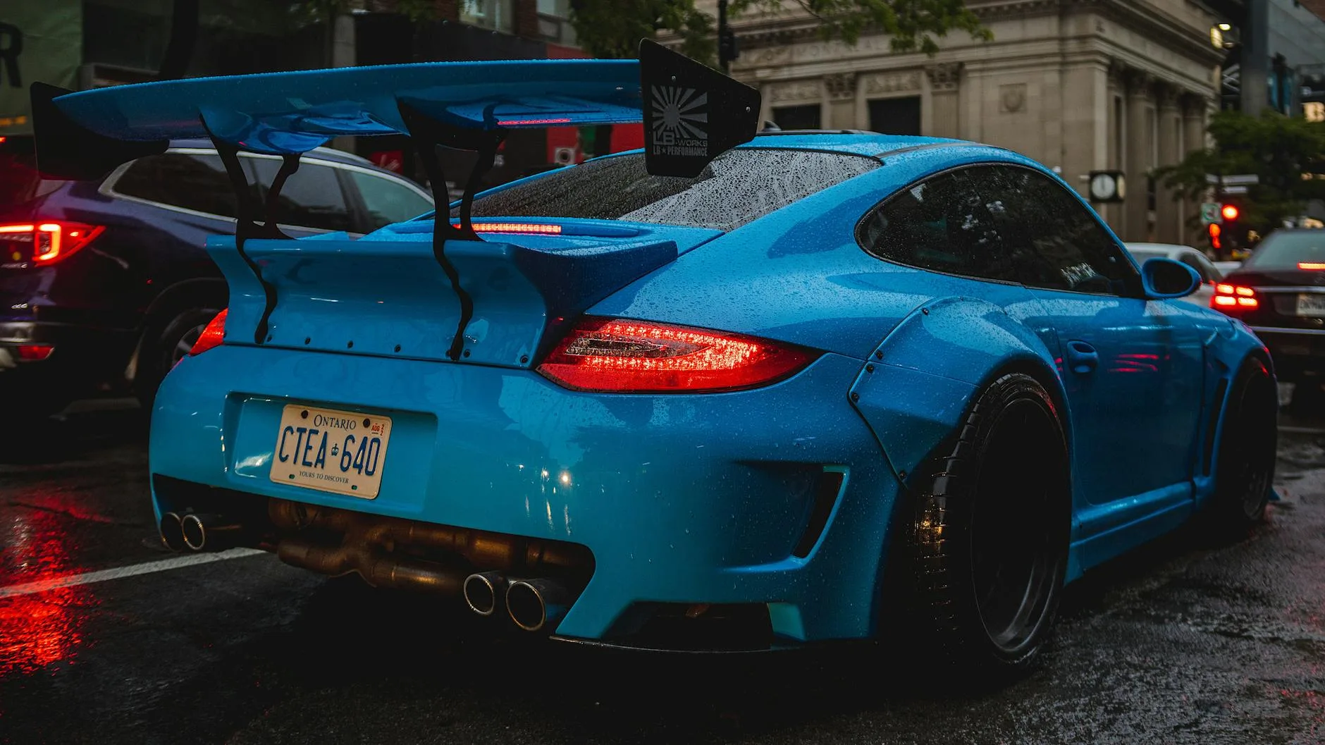 a blue porsche car parked on the street