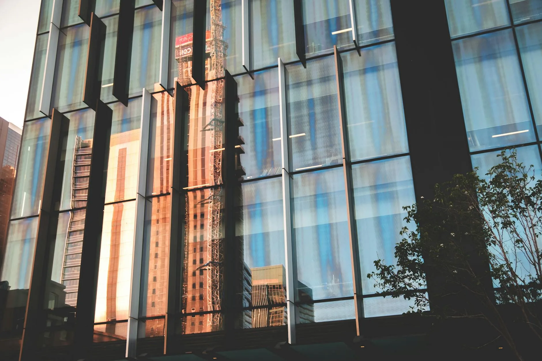 modern facade of building reflecting street of city